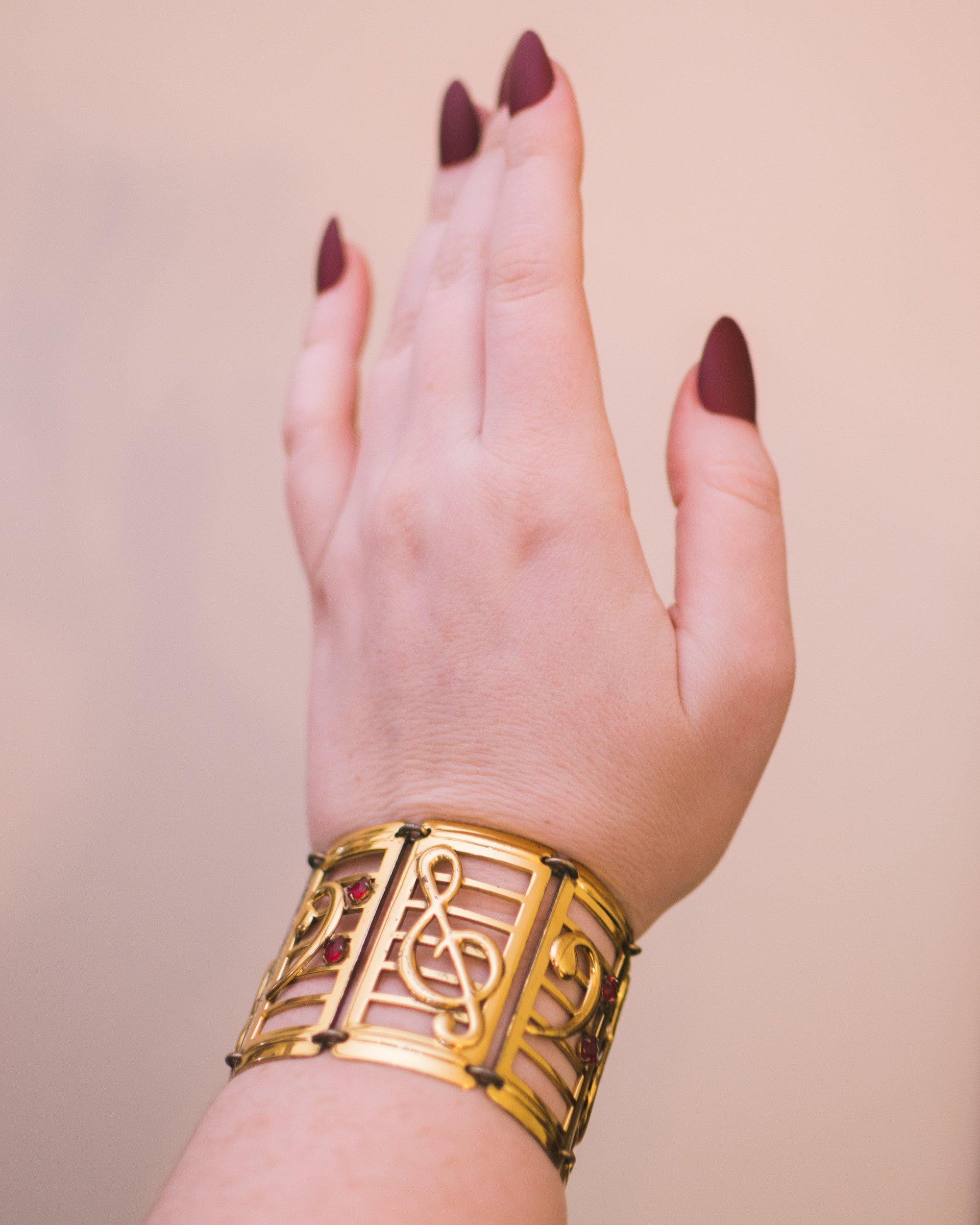 Vintage 1940s Gold and Sterling Silver Wide Panel Music Note Bracelet with Red Rhinestones by 1940s - Vintage Meet Modern Vintage Jewelry - Chicago, Illinois - #oldhollywoodglamour #vintagemeetmodern #designervintage #jewelrybox #antiquejewelry #vintagejewelry