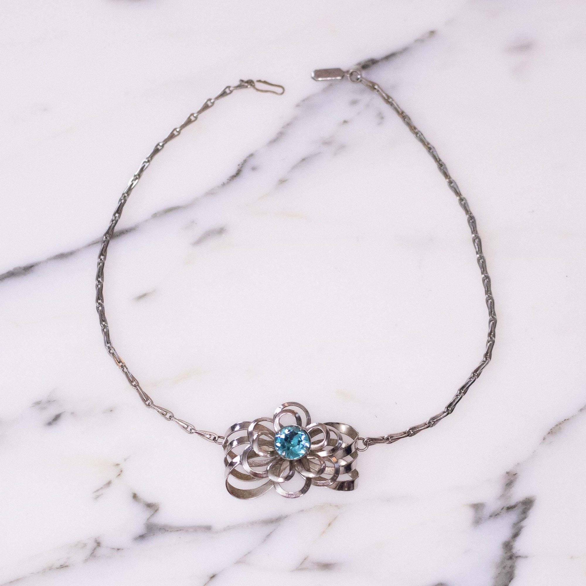 Vintage Mid Century Modern Silver Flower Necklace with Blue Rhinestone by Unsigned Beauty - Vintage Meet Modern Vintage Jewelry - Chicago, Illinois - #oldhollywoodglamour #vintagemeetmodern #designervintage #jewelrybox #antiquejewelry #vintagejewelry