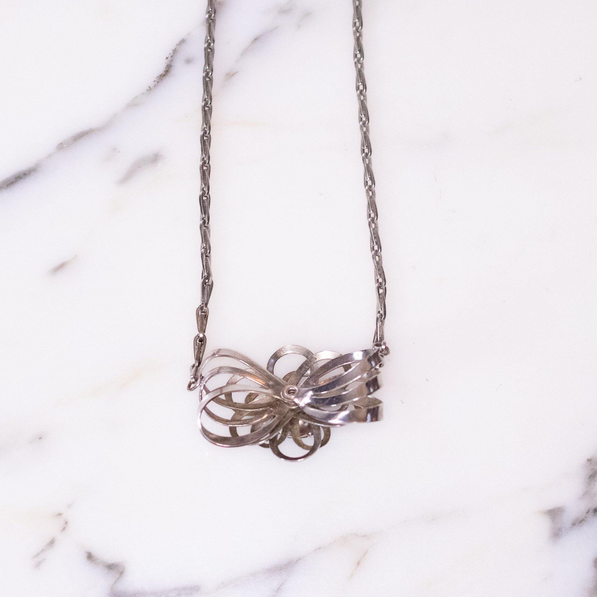 Vintage Mid Century Modern Silver Flower Necklace with Blue Rhinestone by Unsigned Beauty - Vintage Meet Modern Vintage Jewelry - Chicago, Illinois - #oldhollywoodglamour #vintagemeetmodern #designervintage #jewelrybox #antiquejewelry #vintagejewelry