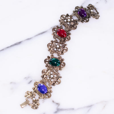 Vintage 1950s Victorian Revival Bracelet with Ornate Panel Links Colorful Jewel Tone Cabochons and Faux Pearls by Vintage Meet Modern - Vintage Meet Modern Vintage Jewelry - Chicago, Illinois - #oldhollywoodglamour #vintagemeetmodern #designervintage #jewelrybox #antiquejewelry #vintagejewelry