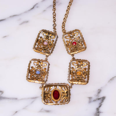 Vintage 1940s Czech Gilt Necklace with Jewel Tone Rhinestones in Red, Blue, Yellow, and Purple by Vintage Meet Modern - Vintage Meet Modern Vintage Jewelry - Chicago, Illinois - #oldhollywoodglamour #vintagemeetmodern #designervintage #jewelrybox #antiquejewelry #vintagejewelry