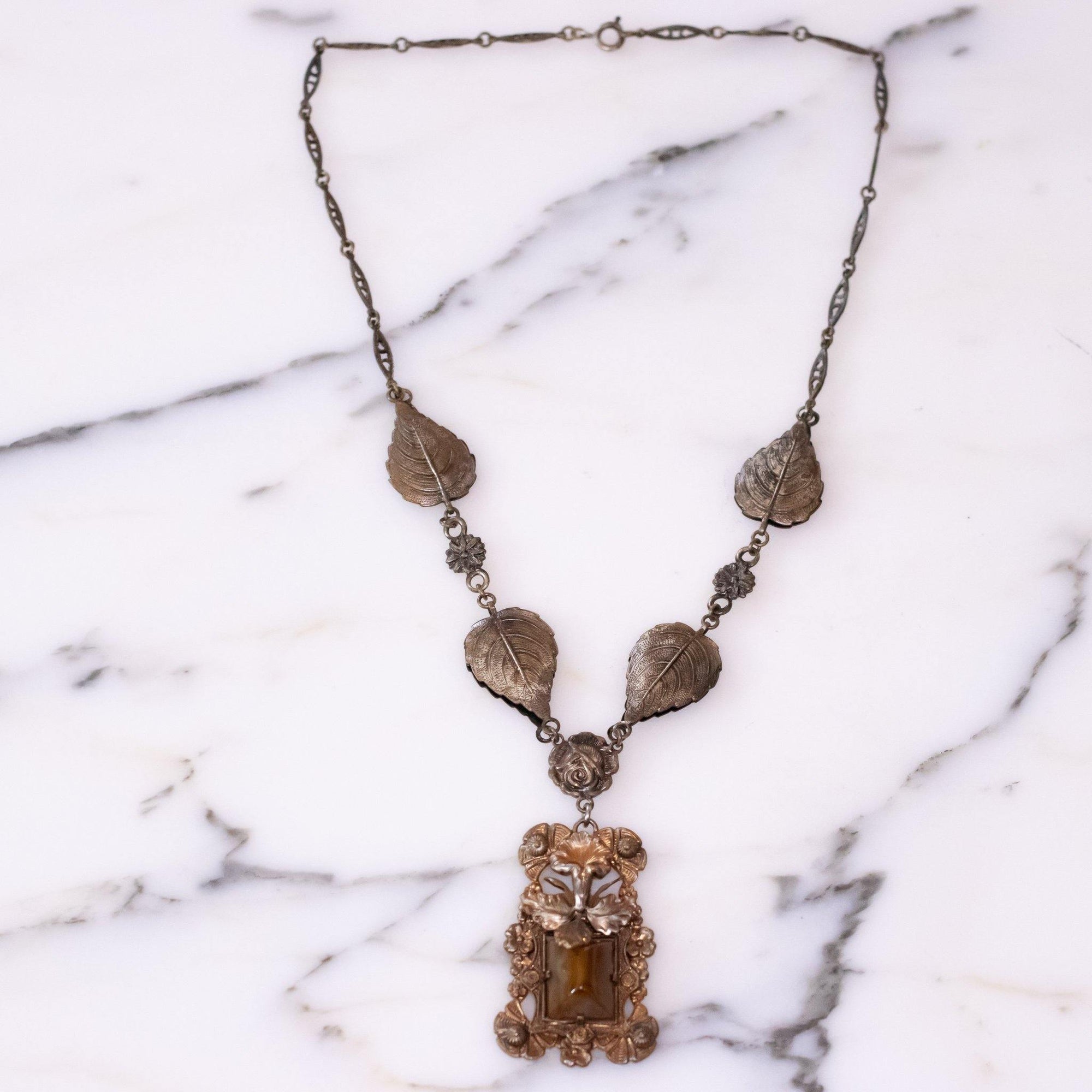 Vintage Art Nouveau Czech Floral Embossed Pendant Necklace with Butterscotch Glass Center by Vintage Meet Modern - Vintage Meet Modern Vintage Jewelry - Chicago, Illinois - #oldhollywoodglamour #vintagemeetmodern #designervintage #jewelrybox #antiquejewelry #vintagejewelry