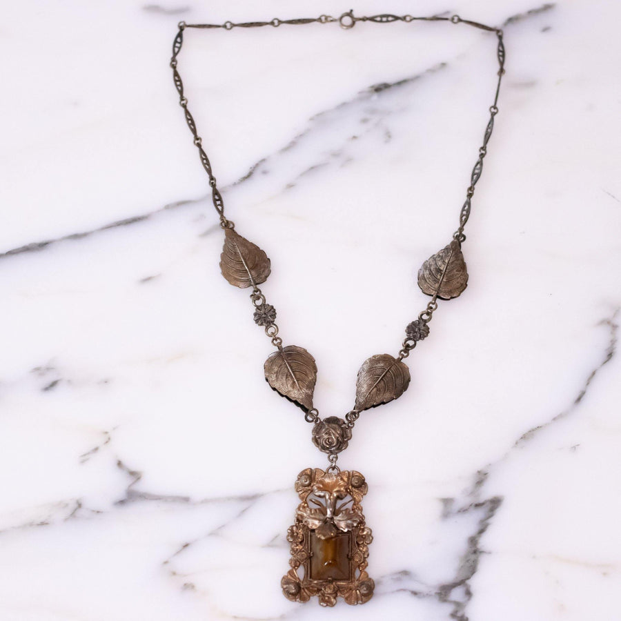 Vintage Art Nouveau Czech Floral Embossed Pendant Necklace with Butterscotch Glass Center by Vintage Meet Modern - Vintage Meet Modern Vintage Jewelry - Chicago, Illinois - #oldhollywoodglamour #vintagemeetmodern #designervintage #jewelrybox #antiquejewelry #vintagejewelry