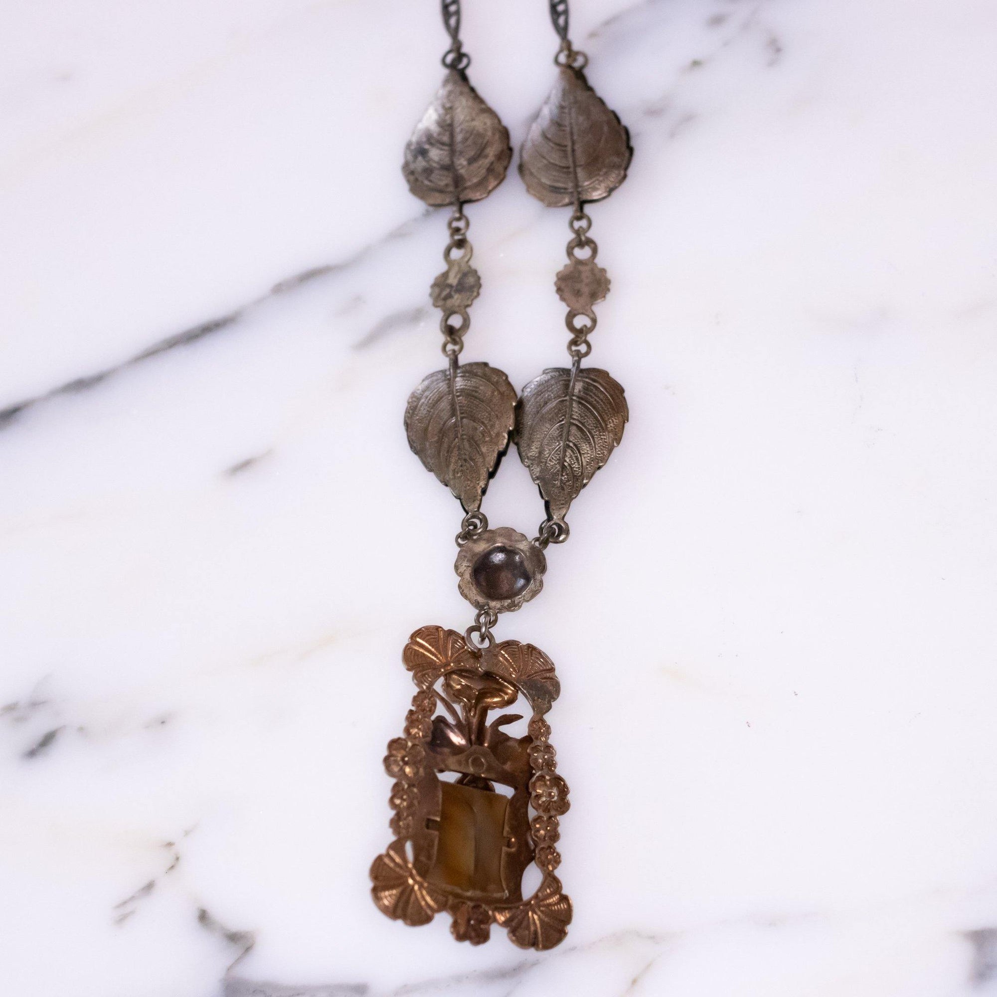 Vintage Art Nouveau Czech Floral Embossed Pendant Necklace with Butterscotch Glass Center by Vintage Meet Modern - Vintage Meet Modern Vintage Jewelry - Chicago, Illinois - #oldhollywoodglamour #vintagemeetmodern #designervintage #jewelrybox #antiquejewelry #vintagejewelry