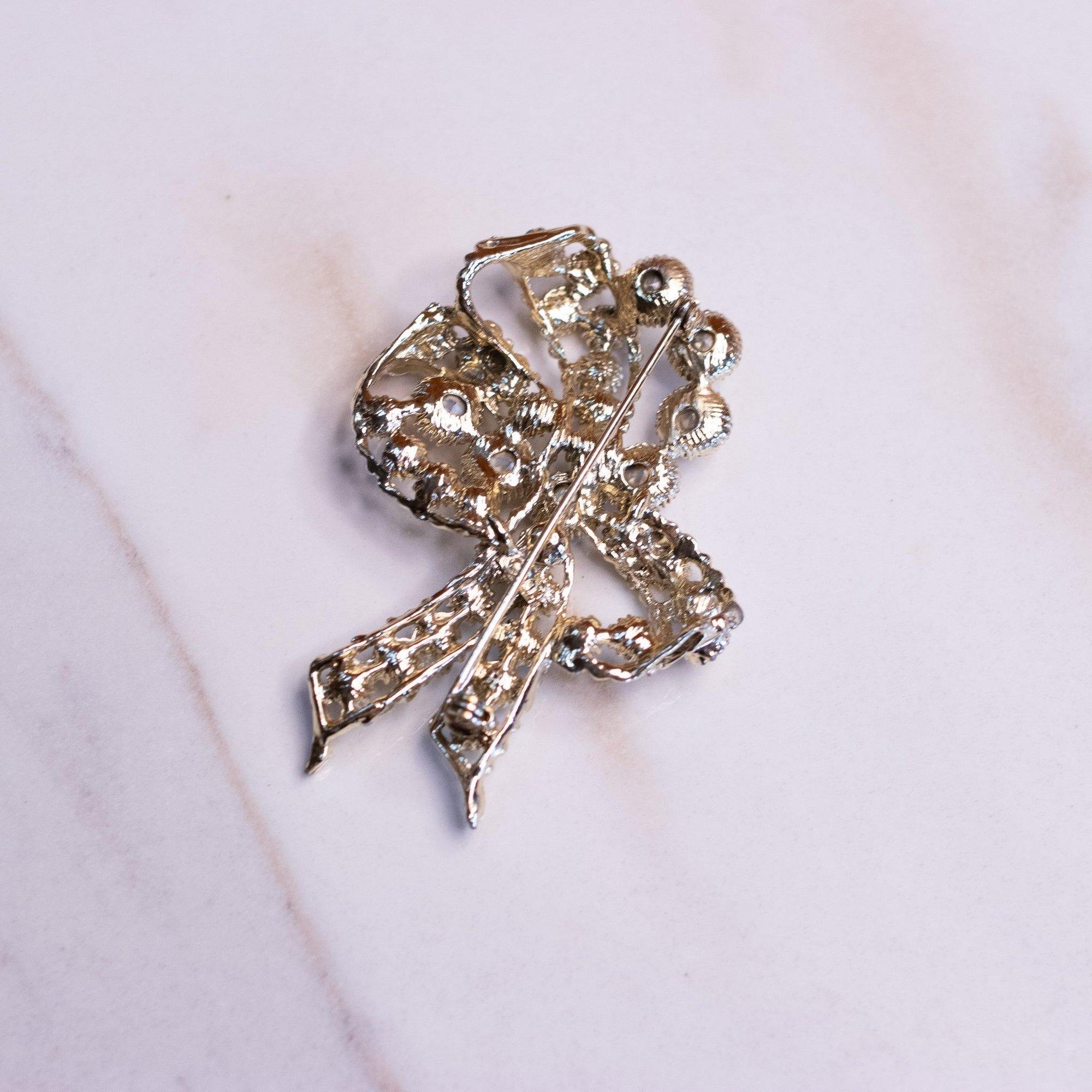 Vintage Lisner Gold Bow Brooch with Aurora Borealis Rhinestones by Lisner - Vintage Meet Modern Vintage Jewelry - Chicago, Illinois - #oldhollywoodglamour #vintagemeetmodern #designervintage #jewelrybox #antiquejewelry #vintagejewelry