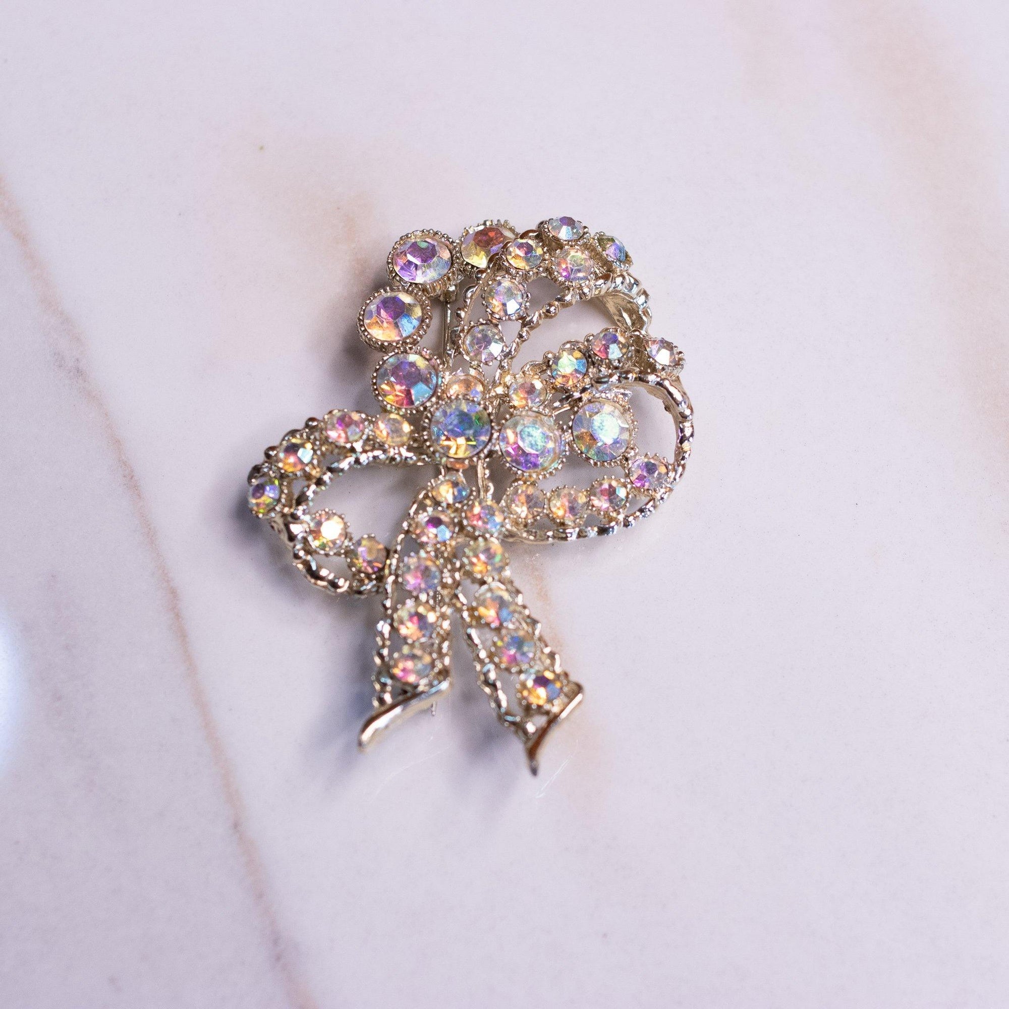 Vintage Lisner Gold Bow Brooch with Aurora Borealis Rhinestones by Lisner - Vintage Meet Modern Vintage Jewelry - Chicago, Illinois - #oldhollywoodglamour #vintagemeetmodern #designervintage #jewelrybox #antiquejewelry #vintagejewelry