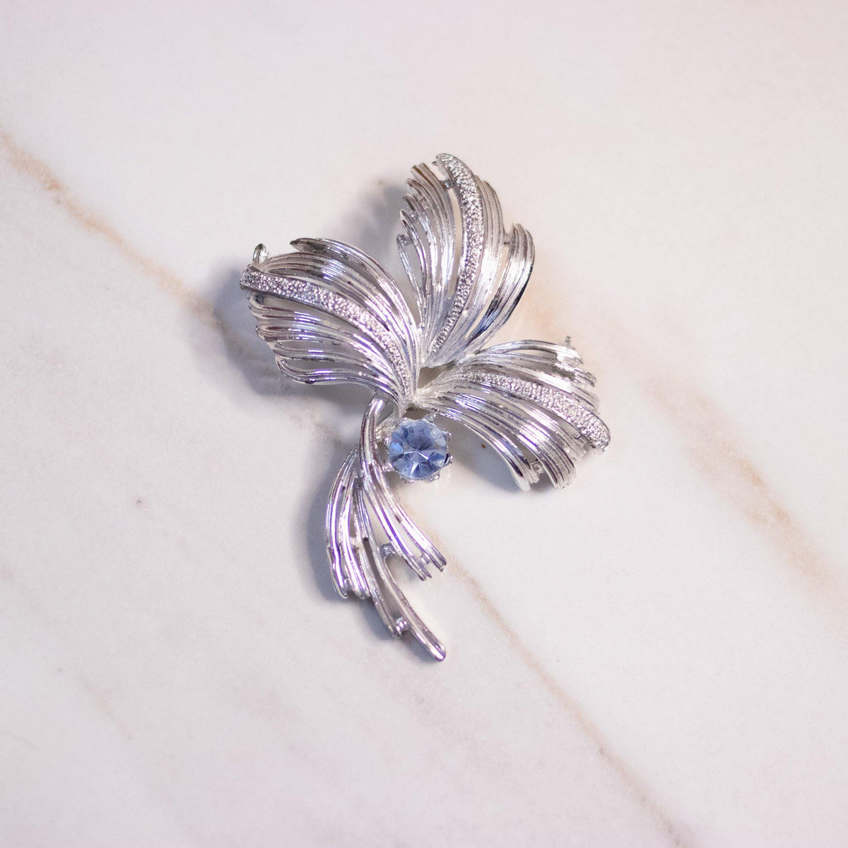 Vintage Mid Century Modern Silver Swirl Brooch with Light Blue Rhinestone