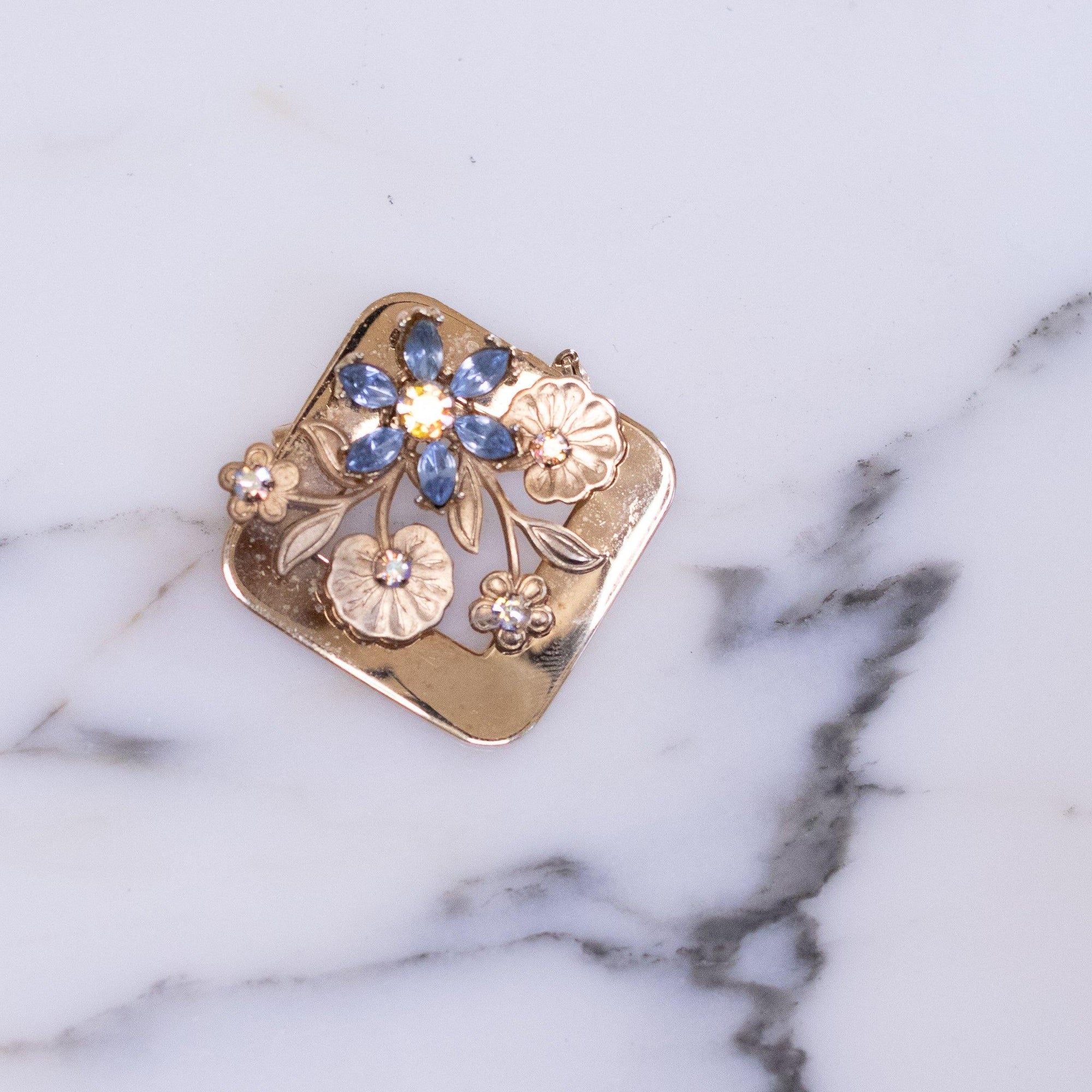 Vintage Gold Square Brooch Adorned with Blue Rhinestone Flowers and Gold Leaves by Unsigned - Vintage Meet Modern Vintage Jewelry - Chicago, Illinois - #oldhollywoodglamour #vintagemeetmodern #designervintage #jewelrybox #antiquejewelry #vintagejewelry
