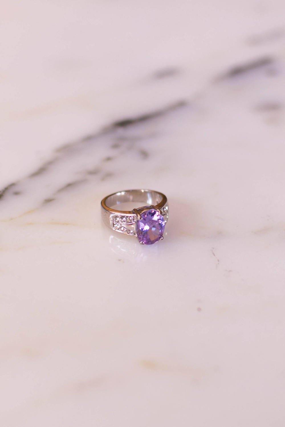 Iolite Oval Solitaire Ring with Pave Cubic Ziroconia Accents set in Silver Tone