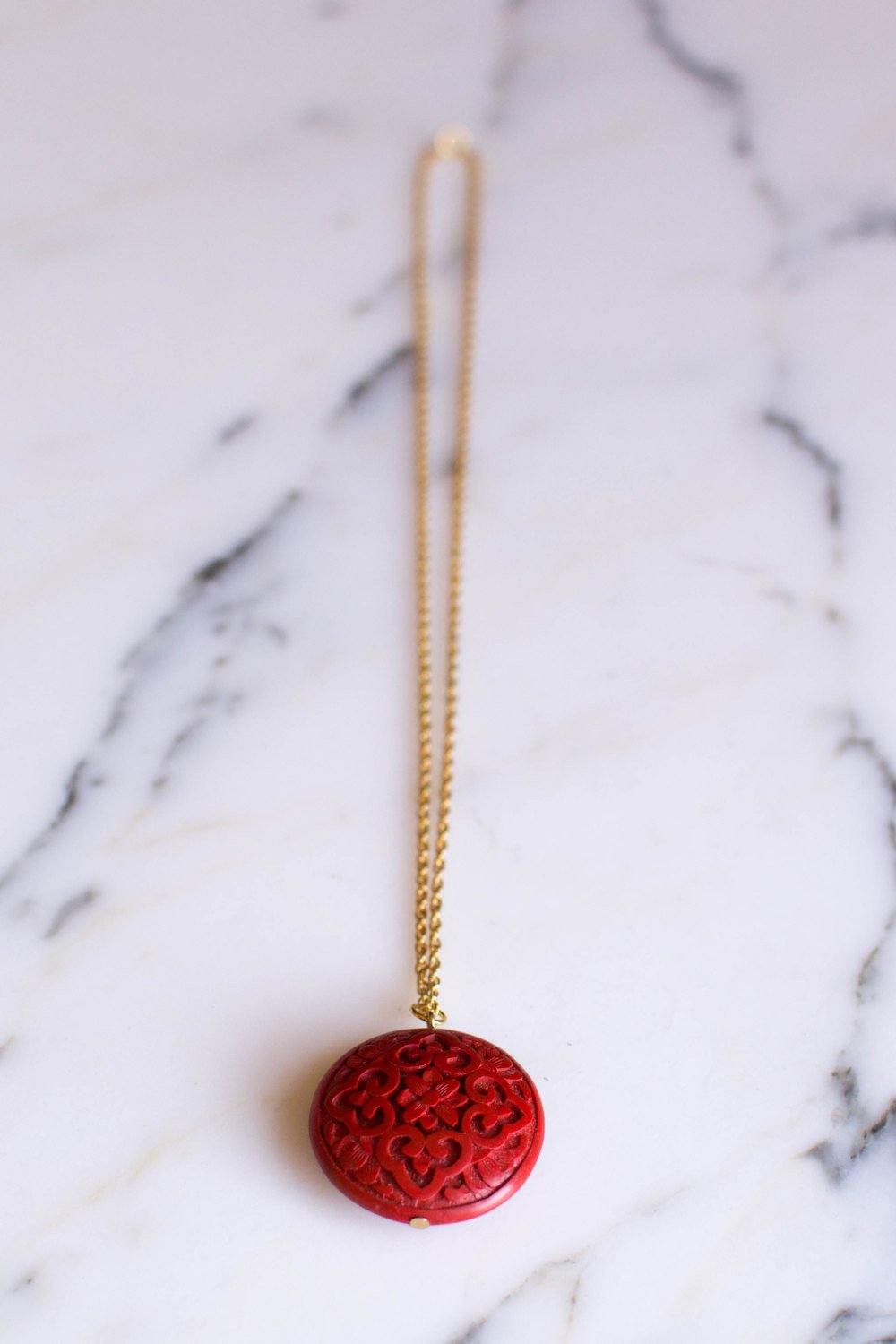 Carved Cinnabar Medallion Pendant Necklace by Chinese Export - Vintage Meet Modern Vintage Jewelry - Chicago, Illinois - #oldhollywoodglamour #vintagemeetmodern #designervintage #jewelrybox #antiquejewelry #vintagejewelry