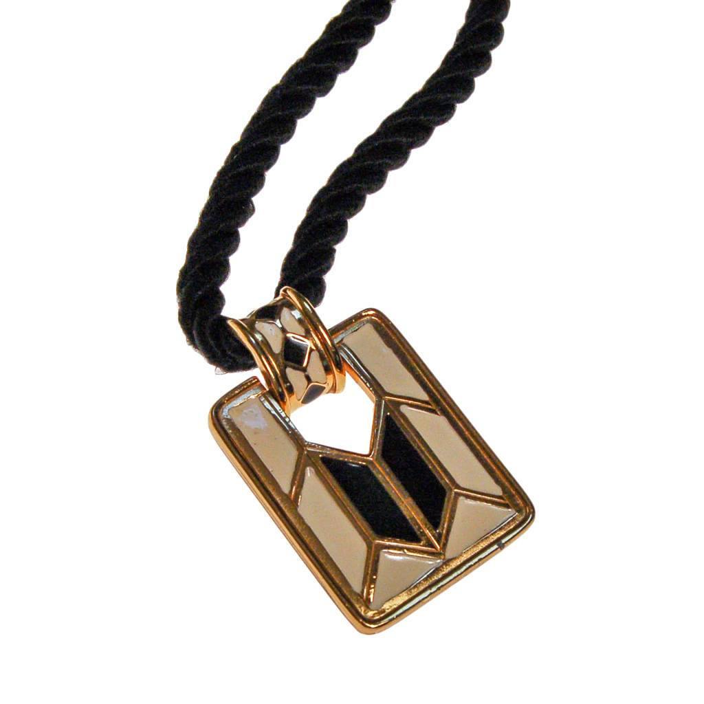 Diane von Furstenberg Cream and Black Pendant Necklace, Statement Necklace, Long Black Cord by Diane Von Furstenberg - Vintage Meet Modern Vintage Jewelry - Chicago, Illinois - #oldhollywoodglamour #vintagemeetmodern #designervintage #jewelrybox #antiquejewelry #vintagejewelry