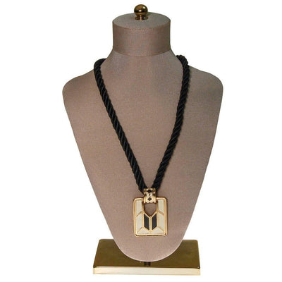 Diane von Furstenberg Cream and Black Pendant Necklace, Statement Necklace, Long Black Cord by Diane Von Furstenberg - Vintage Meet Modern Vintage Jewelry - Chicago, Illinois - #oldhollywoodglamour #vintagemeetmodern #designervintage #jewelrybox #antiquejewelry #vintagejewelry