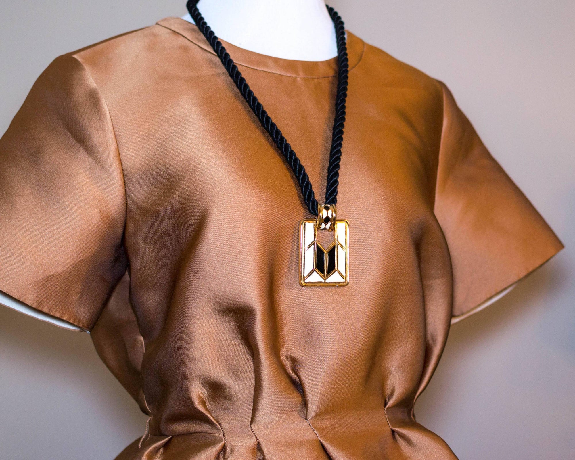 Diane von Furstenberg Cream and Black Pendant Necklace, Statement Necklace, Long Black Cord by Diane Von Furstenberg - Vintage Meet Modern Vintage Jewelry - Chicago, Illinois - #oldhollywoodglamour #vintagemeetmodern #designervintage #jewelrybox #antiquejewelry #vintagejewelry