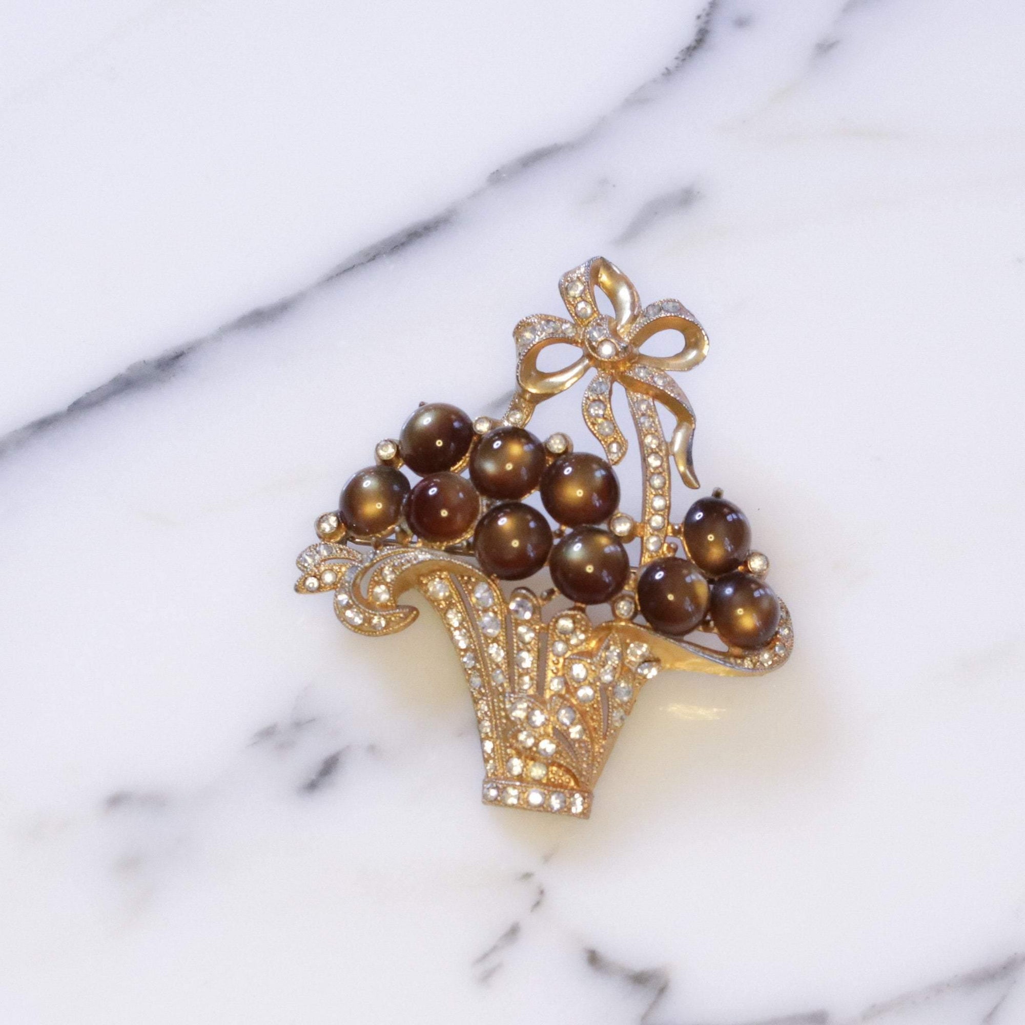 Vintage 1940s Gold Pot Metal Basket Brooch with Brown Cats Eye Moonglow Cabochons and Rhinestones by 1940s - Vintage Meet Modern Vintage Jewelry - Chicago, Illinois - #oldhollywoodglamour #vintagemeetmodern #designervintage #jewelrybox #antiquejewelry #vintagejewelry