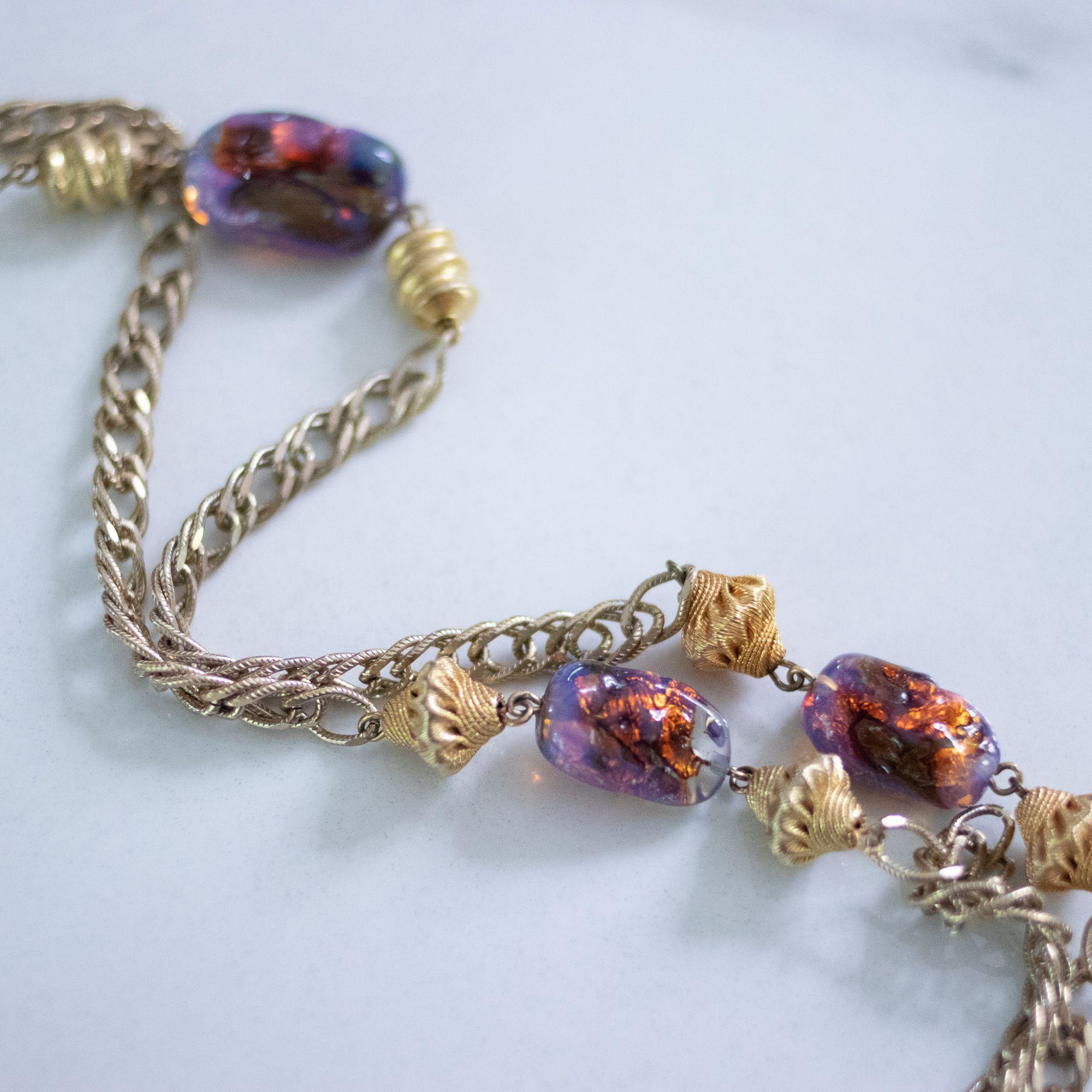 Vintage 1950s Flapper Length Gold and Purple Iridescent Art Glass Necklace by Unsigned Beauty - Vintage Meet Modern Vintage Jewelry - Chicago, Illinois - #oldhollywoodglamour #vintagemeetmodern #designervintage #jewelrybox #antiquejewelry #vintagejewelry