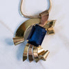 Vintage 1940s Coro Gold Gold Looped Pendant with Sapphire Blue Crystal by Coro - Vintage Meet Modern Vintage Jewelry - Chicago, Illinois - #oldhollywoodglamour #vintagemeetmodern #designervintage #jewelrybox #antiquejewelry #vintagejewelry