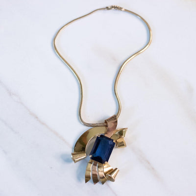 Vintage 1940s Coro Gold Gold Looped Pendant with Sapphire Blue Crystal by Coro - Vintage Meet Modern Vintage Jewelry - Chicago, Illinois - #oldhollywoodglamour #vintagemeetmodern #designervintage #jewelrybox #antiquejewelry #vintagejewelry