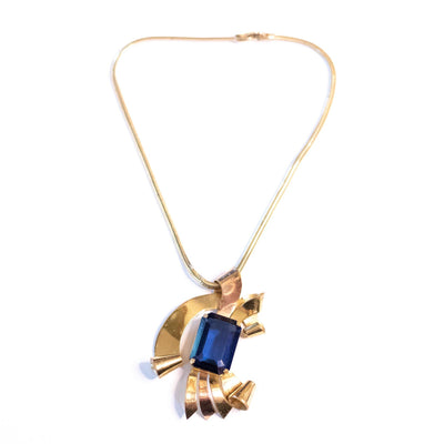 Vintage 1940s Coro Gold Gold Looped Pendant with Sapphire Blue Crystal by Coro - Vintage Meet Modern Vintage Jewelry - Chicago, Illinois - #oldhollywoodglamour #vintagemeetmodern #designervintage #jewelrybox #antiquejewelry #vintagejewelry