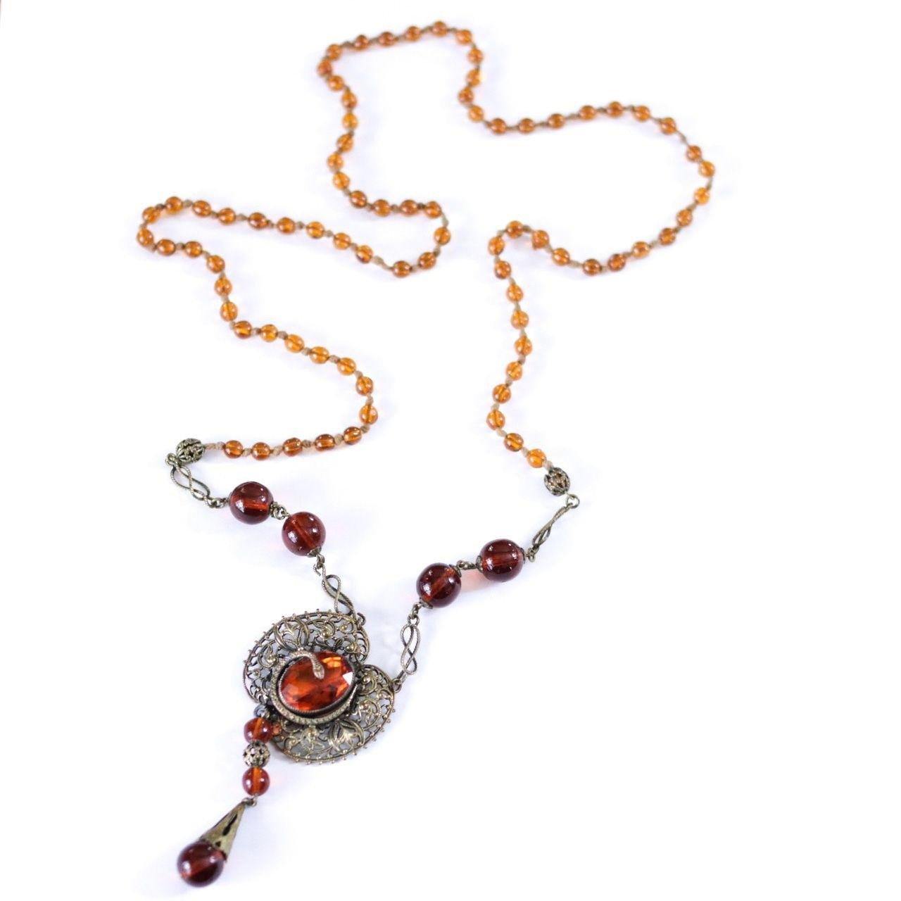 Vintage Long Art Deco Amber Glass Necklace with Brass Accent with Serpent by Czech - Vintage Meet Modern Vintage Jewelry - Chicago, Illinois - #oldhollywoodglamour #vintagemeetmodern #designervintage #jewelrybox #antiquejewelry #vintagejewelry