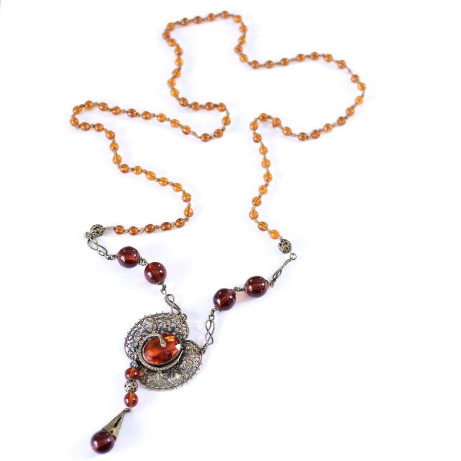 Vintage Long Art Deco Amber Glass Necklace with Brass Accent with Serpent by Czech - Vintage Meet Modern Vintage Jewelry - Chicago, Illinois - #oldhollywoodglamour #vintagemeetmodern #designervintage #jewelrybox #antiquejewelry #vintagejewelry