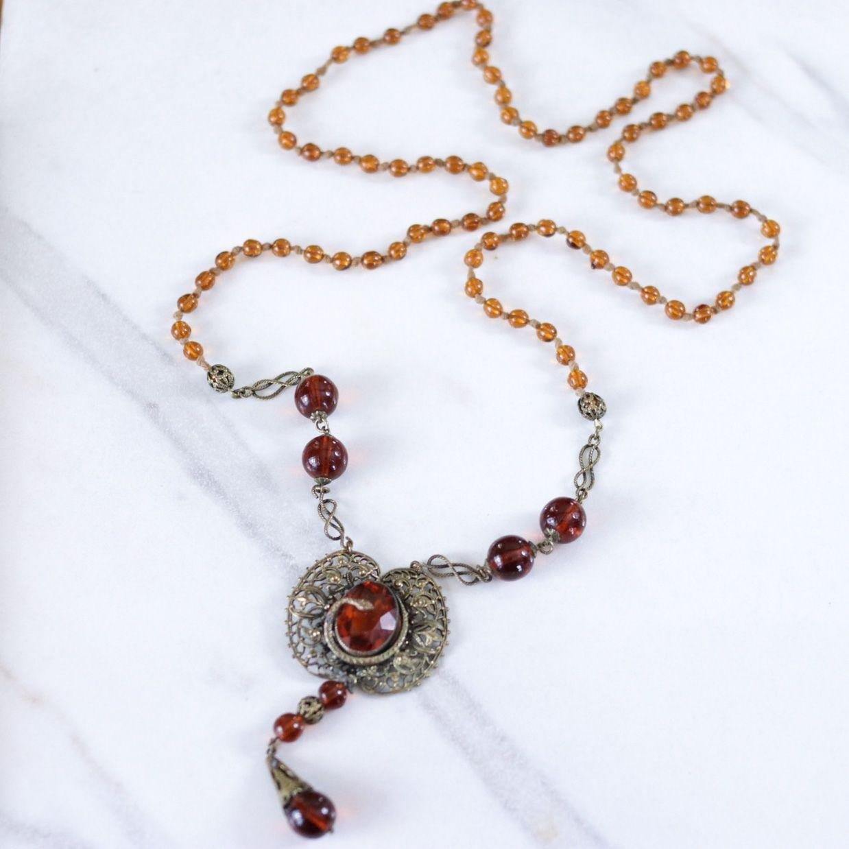 Vintage Long Art Deco Amber Glass Necklace with Brass Accent with Serpent by Czech - Vintage Meet Modern Vintage Jewelry - Chicago, Illinois - #oldhollywoodglamour #vintagemeetmodern #designervintage #jewelrybox #antiquejewelry #vintagejewelry