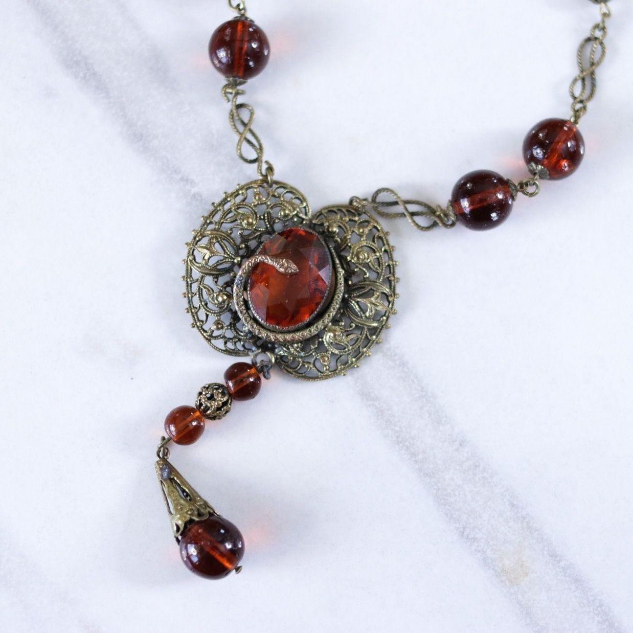 Vintage Long Art Deco Amber Glass Necklace with Brass Accent with Serpent by Czech - Vintage Meet Modern Vintage Jewelry - Chicago, Illinois - #oldhollywoodglamour #vintagemeetmodern #designervintage #jewelrybox #antiquejewelry #vintagejewelry
